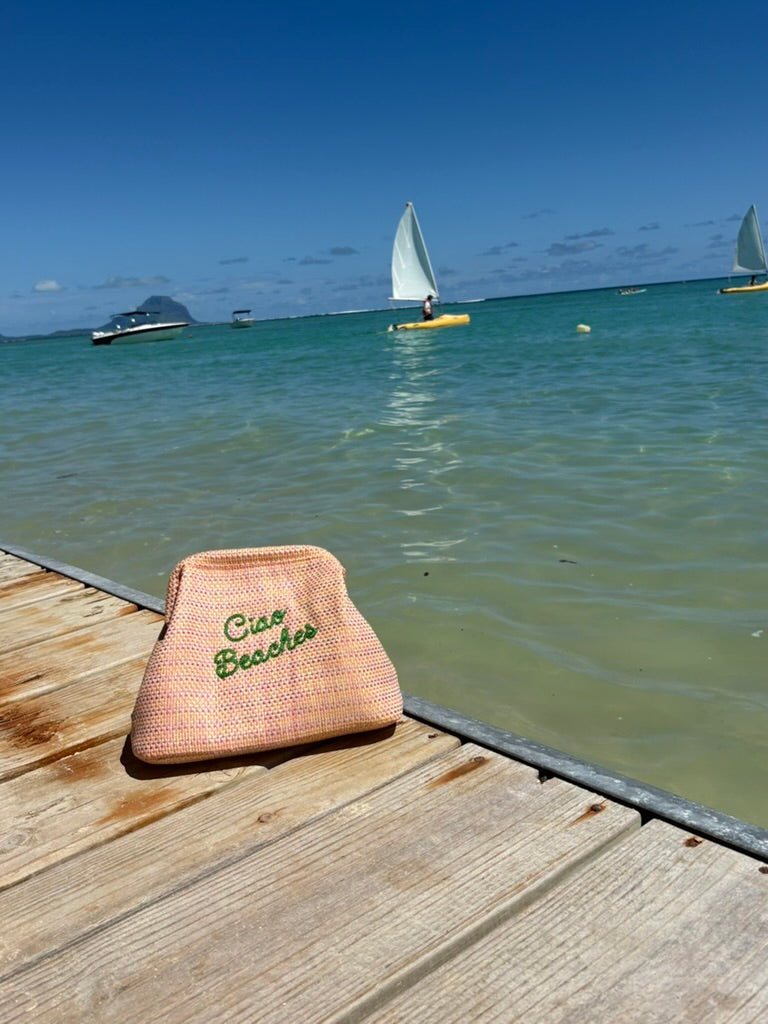 Lilly Loves Ciao Beaches pink clutch pouch with a stylish design, perfect for carrying small essentials in a chic fashion.