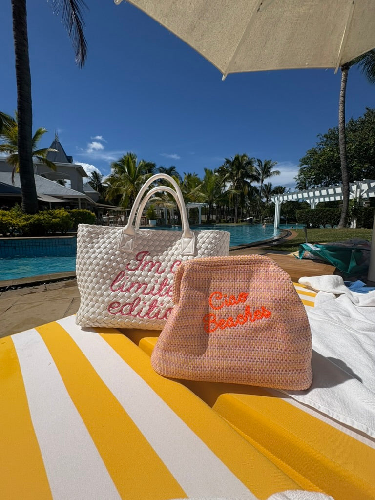 Neon orange Ciao Beaches clutch pouch by Lilly Loves with a vibrant, compact design and zipper closure.