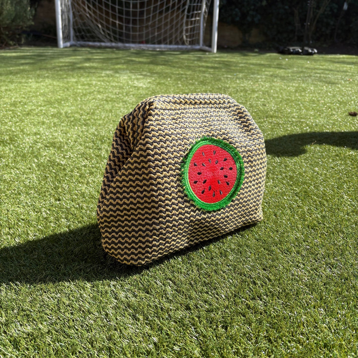 Lilly Loves fluffy watermelon pouch bag featuring a soft plush texture, vibrant green and pink colors.