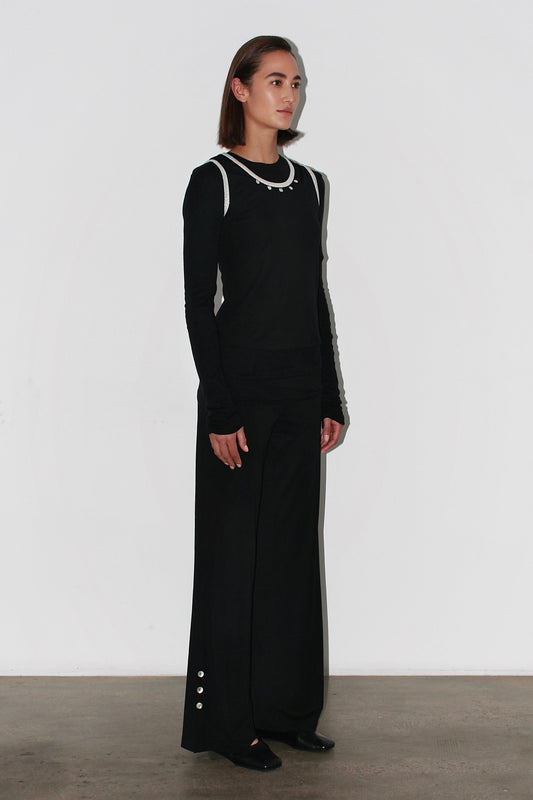 Full outfit – Jade Top and black trousers creating a modern and chic silhouette.