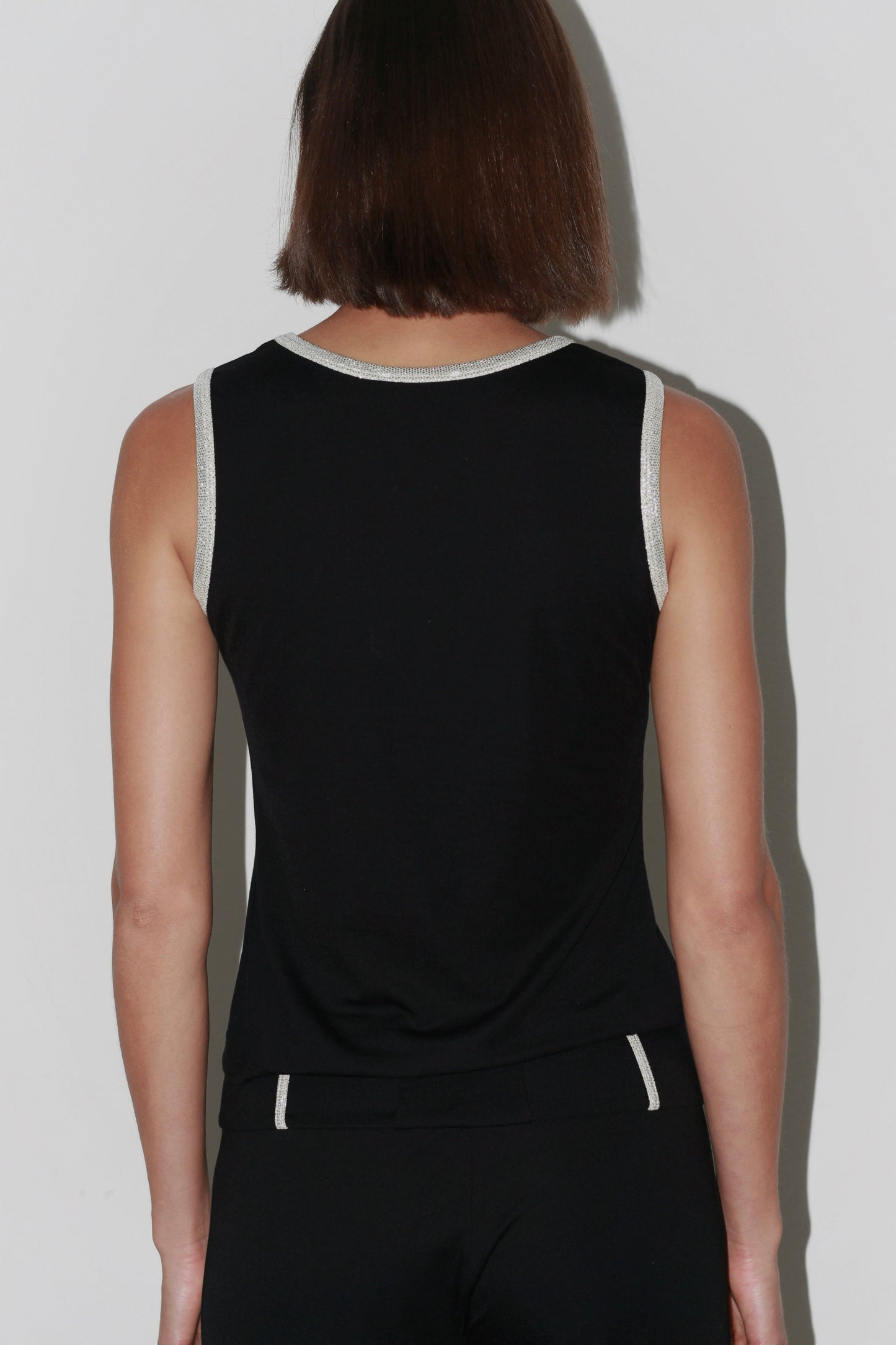 Back view of the Jade Top – simple black design with clean lines and a refined finish.