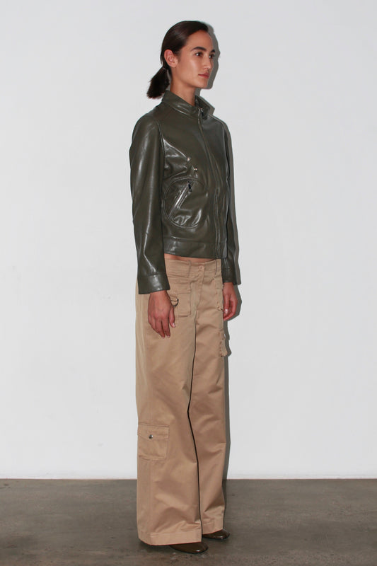 Three-quarter front view – light beige pants paired with an olive green top, modern neutral look.