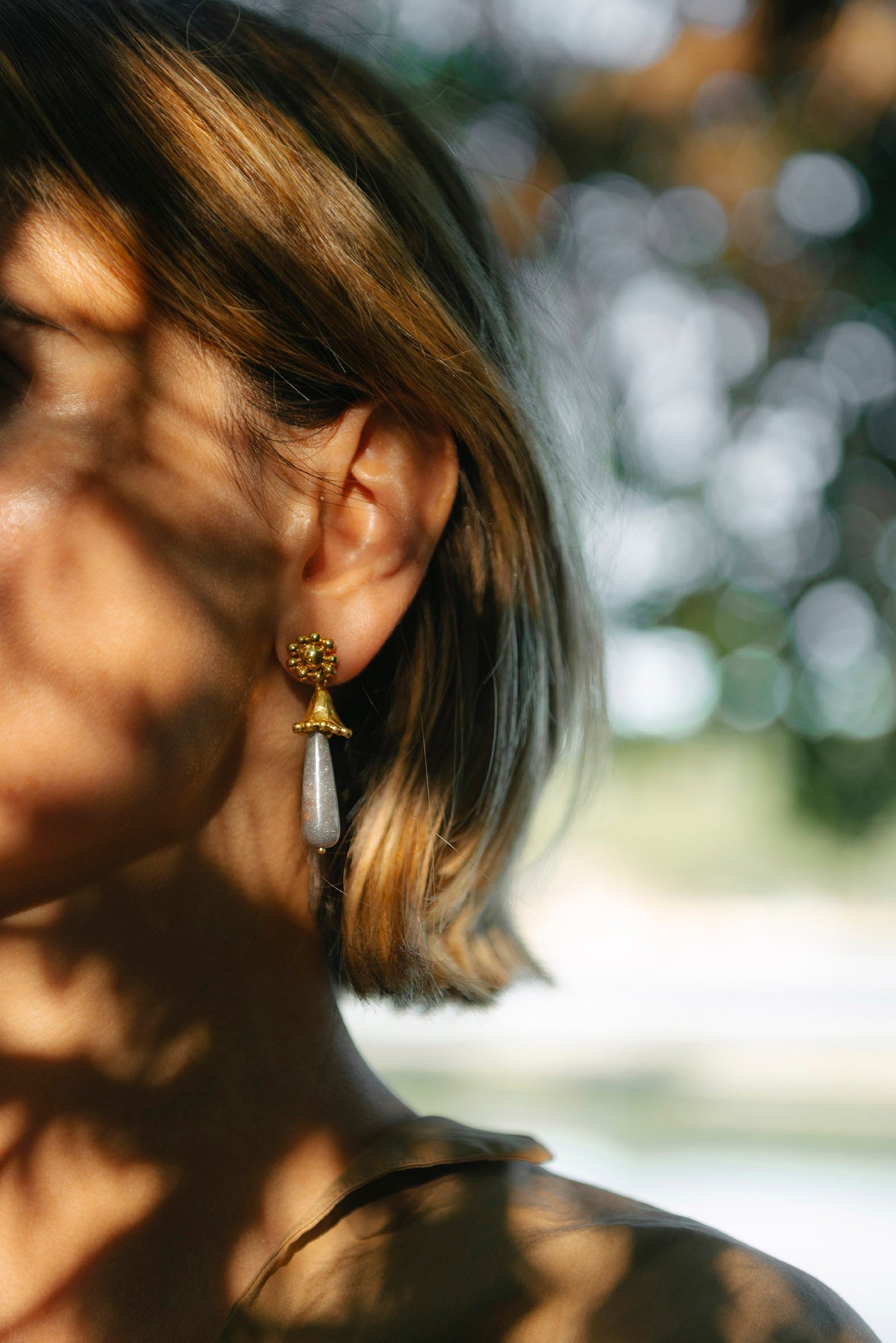 drop earrings coil gold wearing