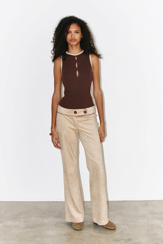 Front view of the Ana Top in brown ribbed knit, featuring a high neckline with three teardrop cutouts and contrast beige trim along the edges.