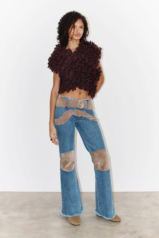 Front view of the Kika Pants – light blue denim pants with a fitted waist and straight leg cut, paired with a brown top.