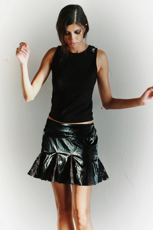 Fashion shot – Bellini Skirt in motion, glossy texture catching the light, Coloma’s modern aesthetic.