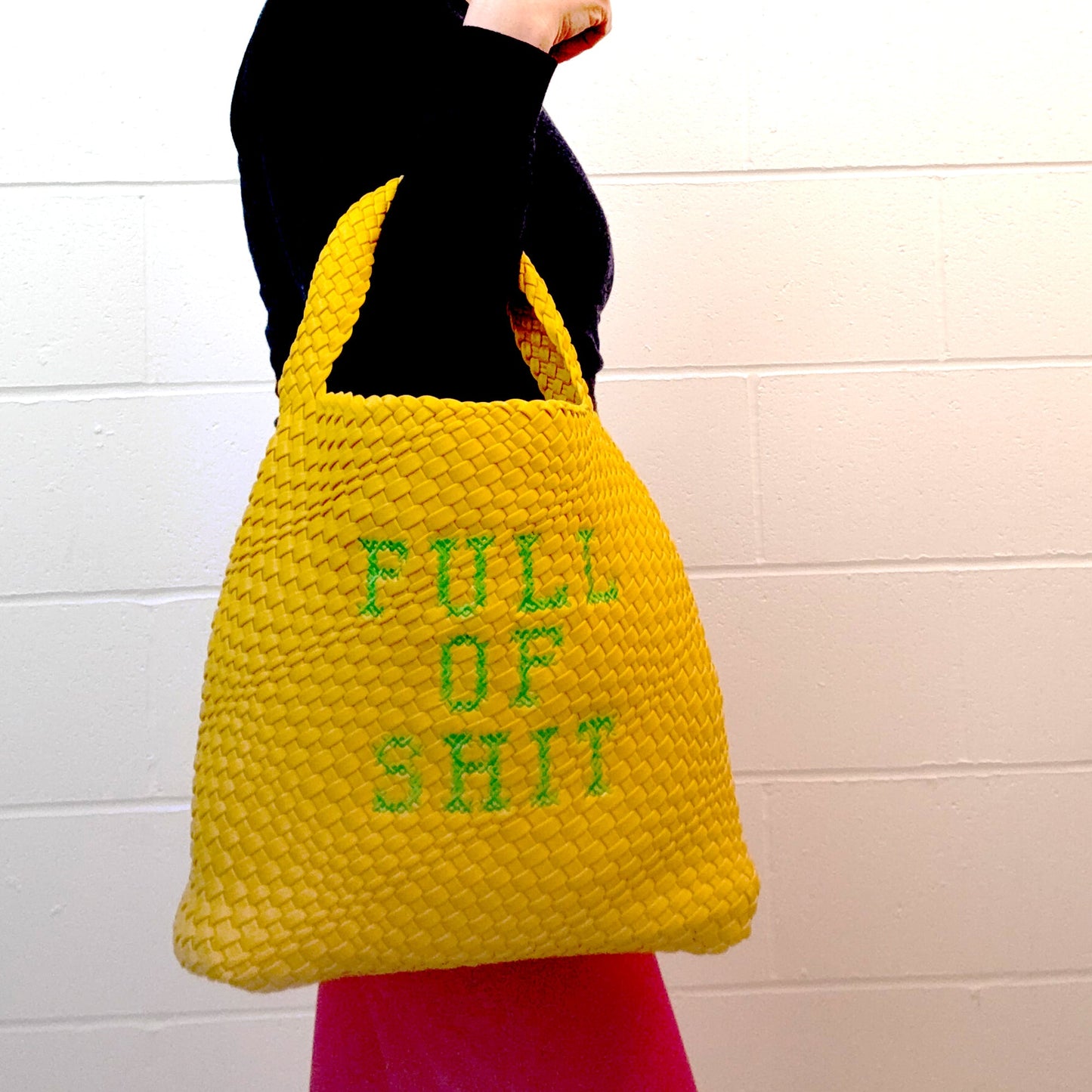 Yellow woven bucket handbag by Lilly Loves with a rounded shape and shoulder strap, featuring a vibrant, textured design.